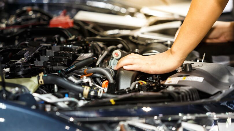 Car Mechanic Fixing Hand Engine Hood