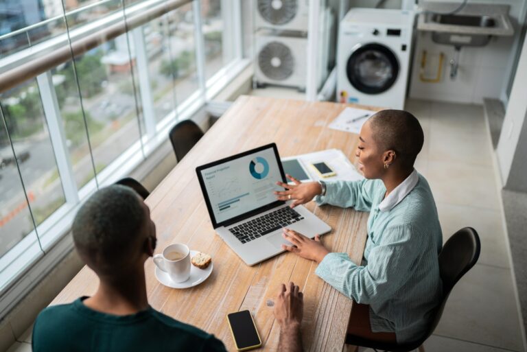 Two Woman Talking With Laptop Computer