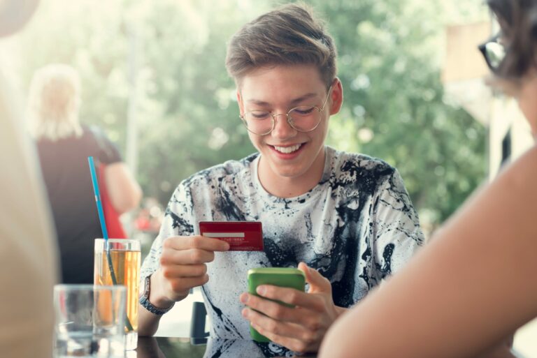 Teenager Holding Debit Card Phone Restaurant