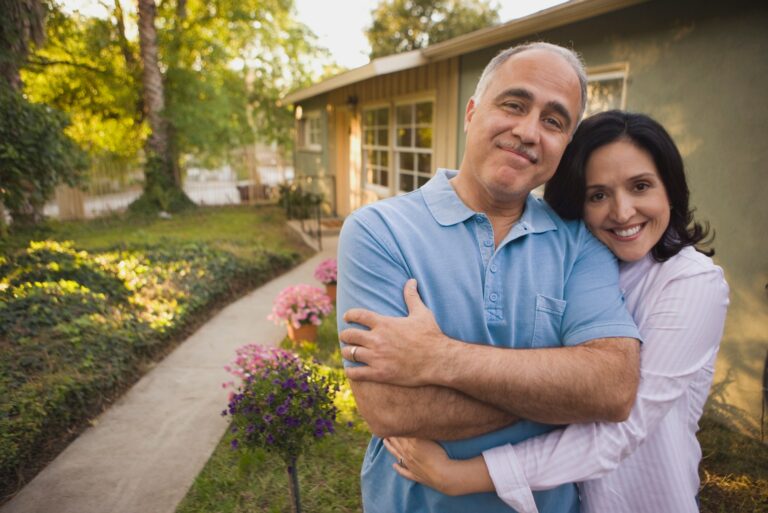 Smiling Couple Outside House